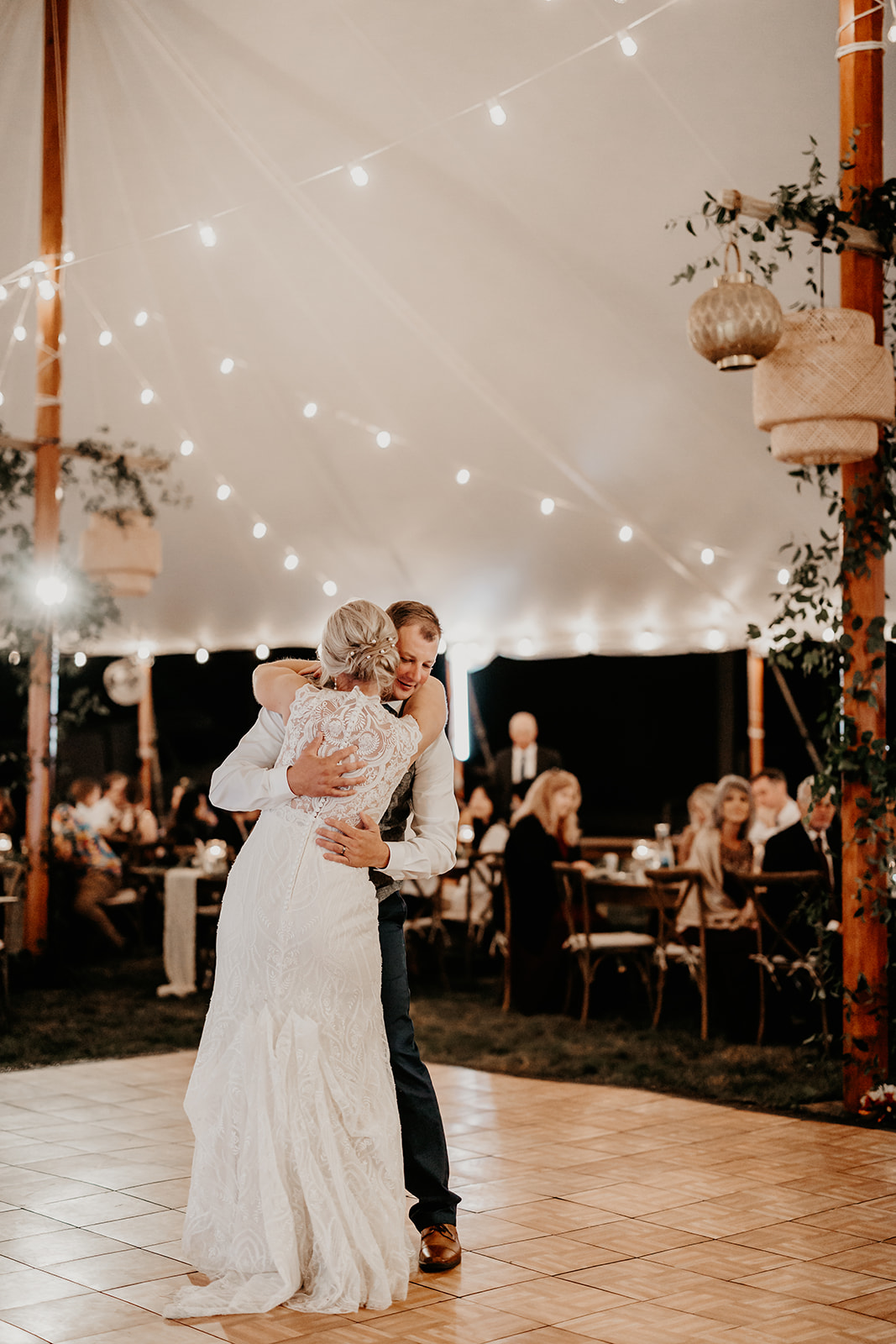 Betsy and Zach embracing on their wedding dance floor